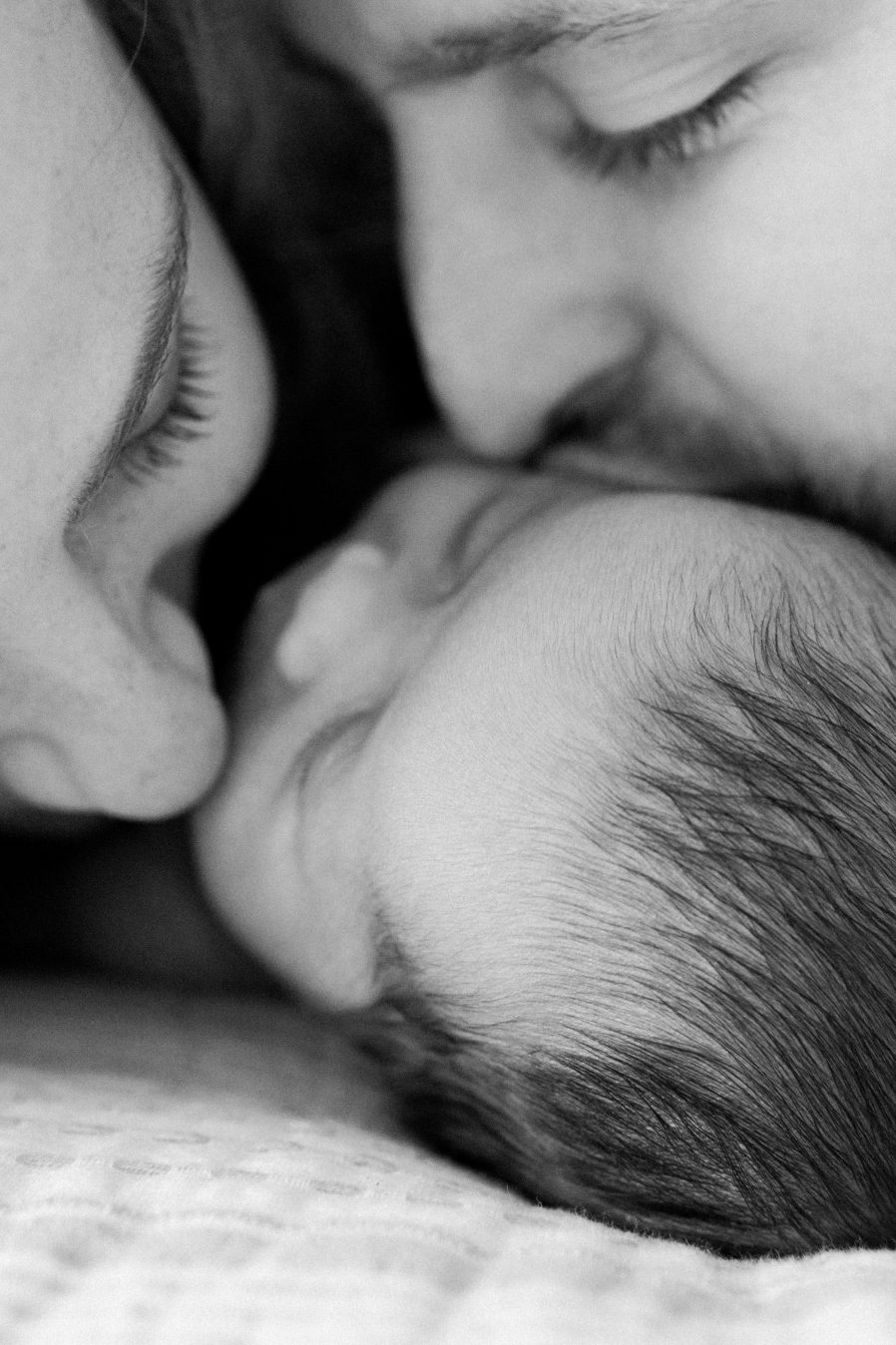 Newborn photography Kuala Lumpur daddy mommy kissing baby