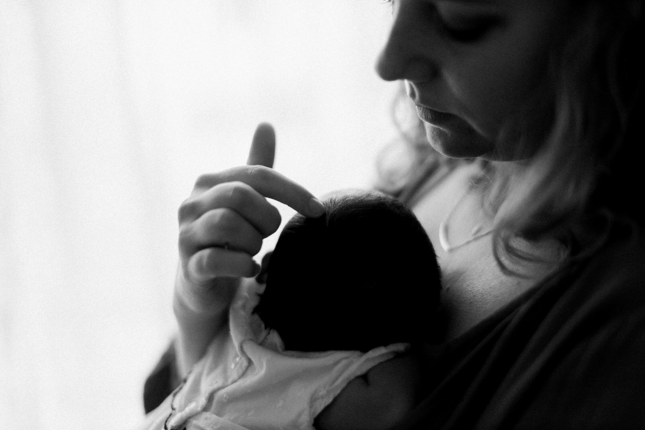 Newborn photography Kuala Lumpur mommy holding baby black and white
