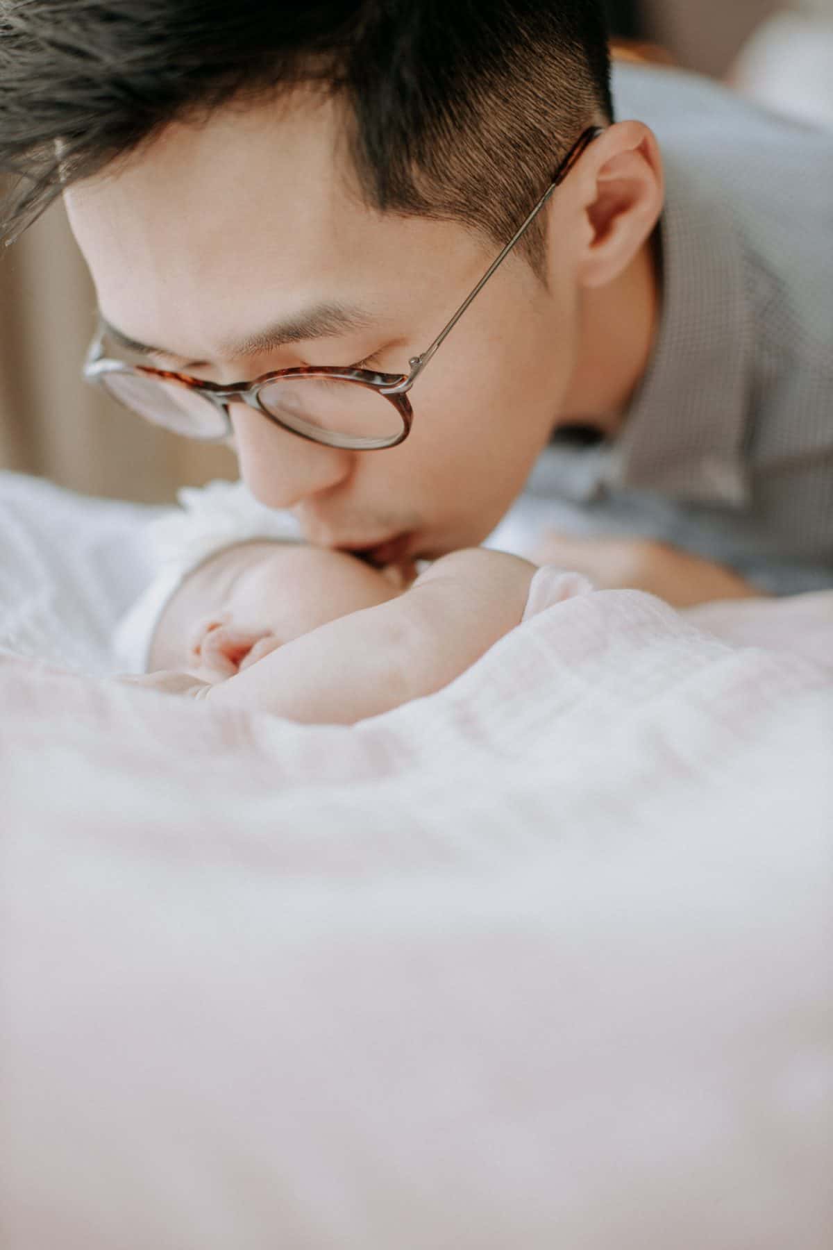 Newborn baby portrait session in Malaysia Cliff Choong Photography daddy kiss