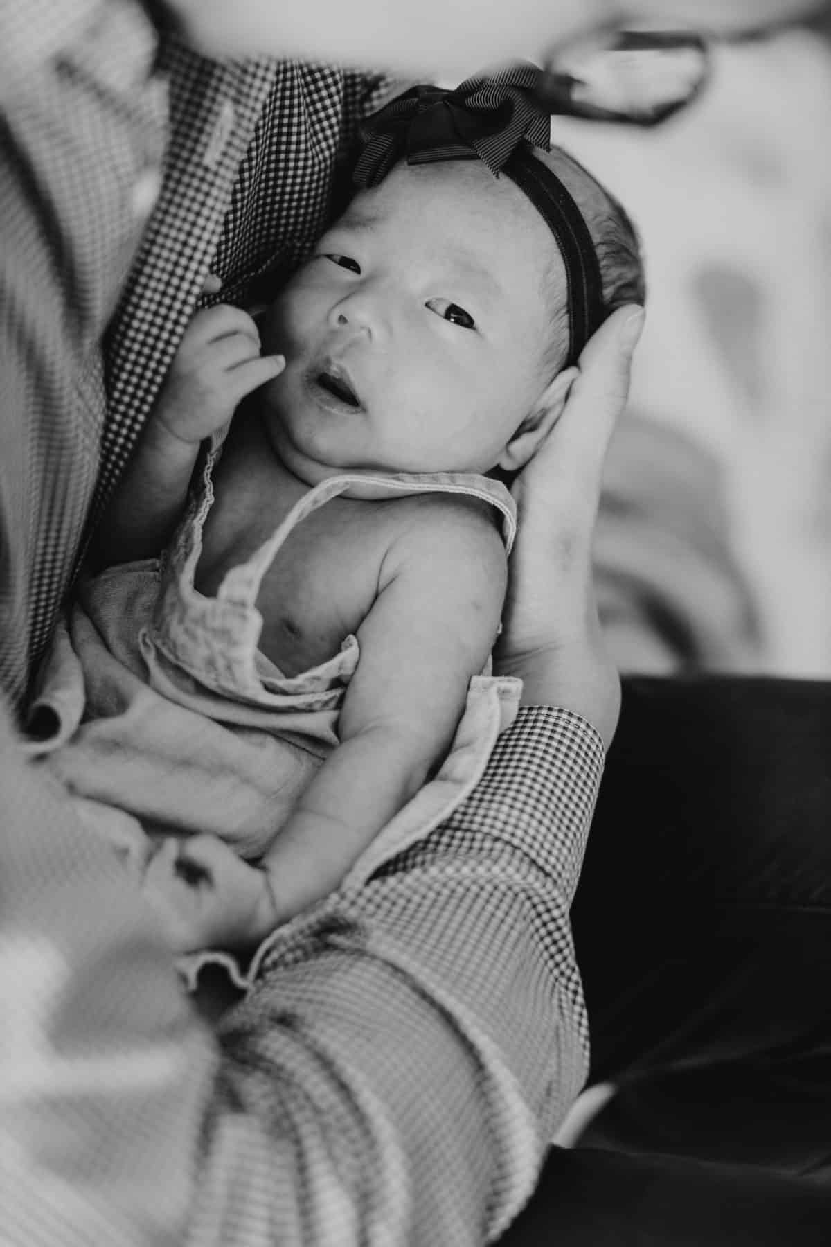 Newborn baby portrait session in Malaysia Cliff Choong Photography in daddy's arms