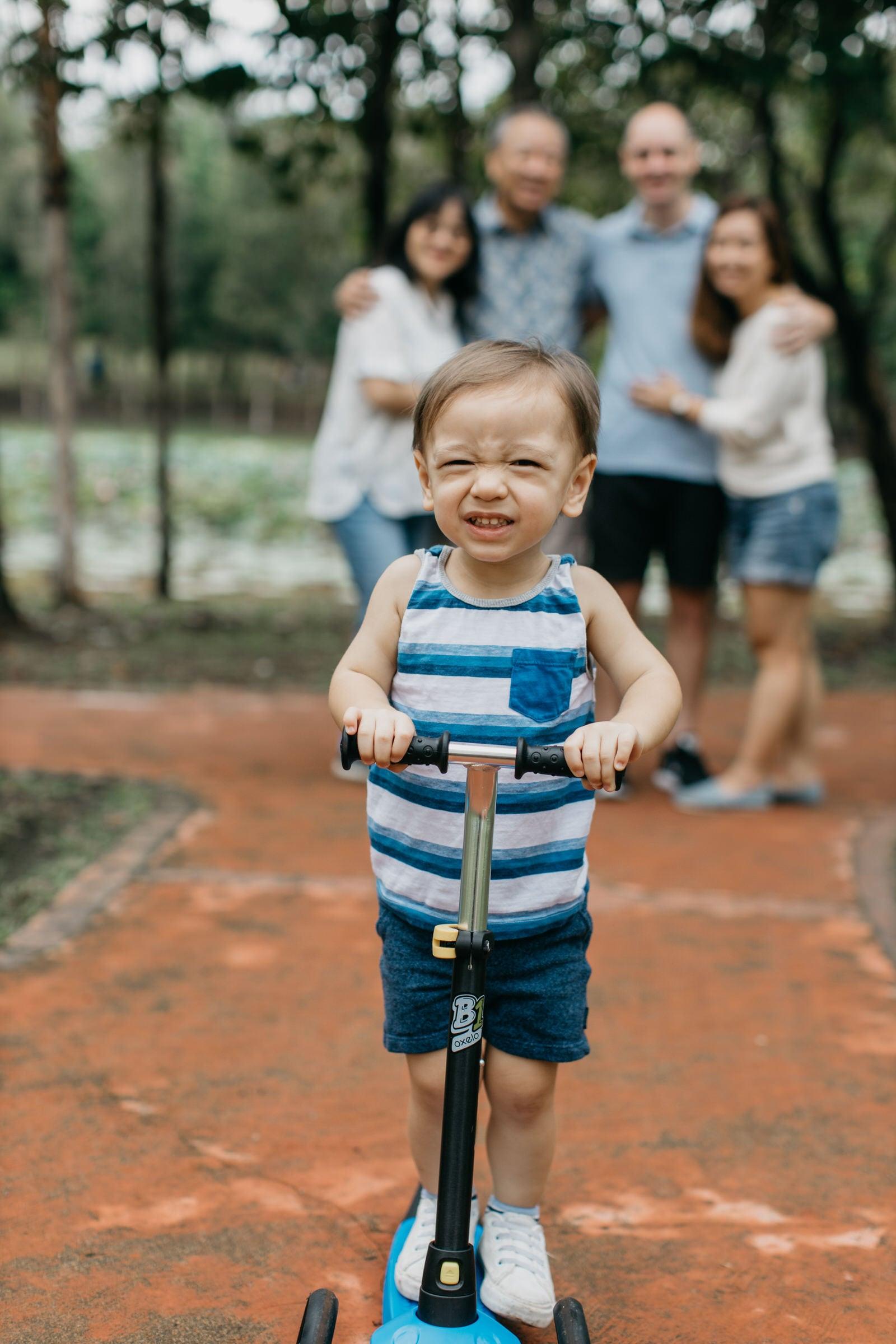 Cute little boy on scooter Damansar Tropical Family Portrait Session in Kuala Lumpur Malaysia