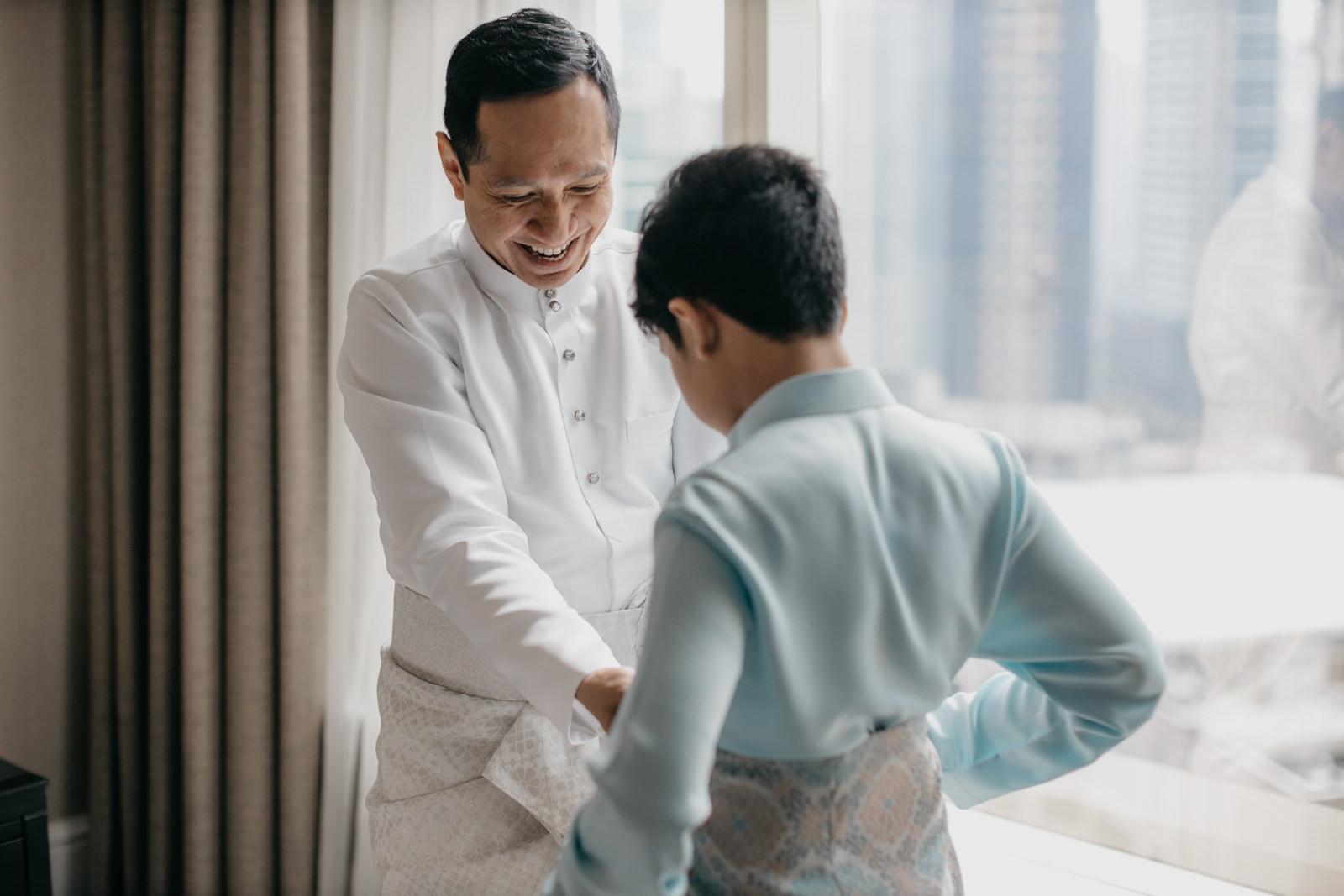 groom getting son in law ready laughter Akad Nikah at JW Marriott Kuala Lumpur