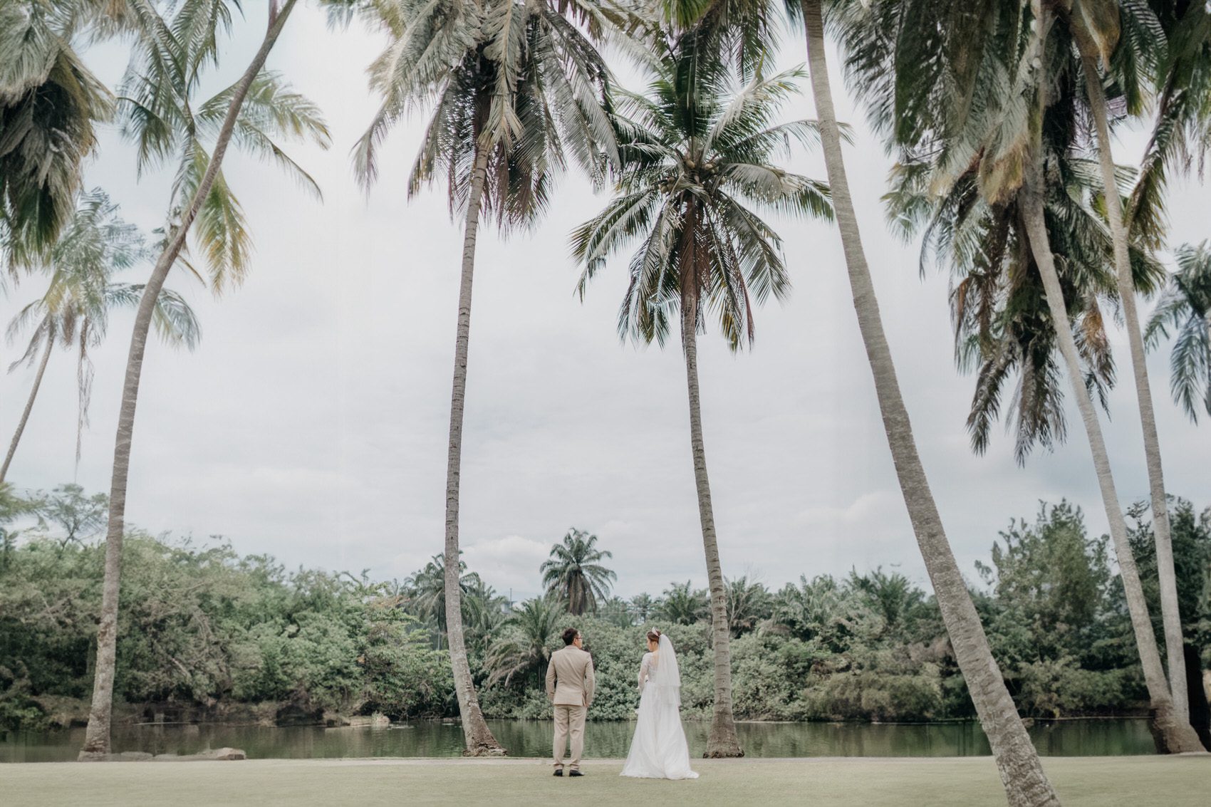 wedding couple post-wedding photo in front of the lake for a garden wedding at The Saujana Hotel Subang Jaya