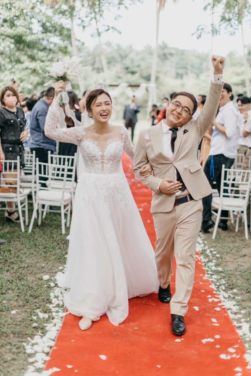 wedding couple happily march out for a garden wedding at The Saujana Hotel Subang Jaya