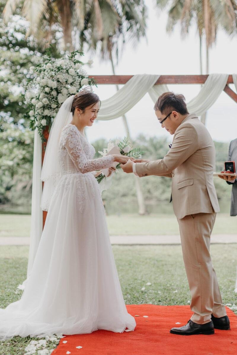 wedding couple exchange vows at a garden wedding at The Saujana Hotel Subang Jaya