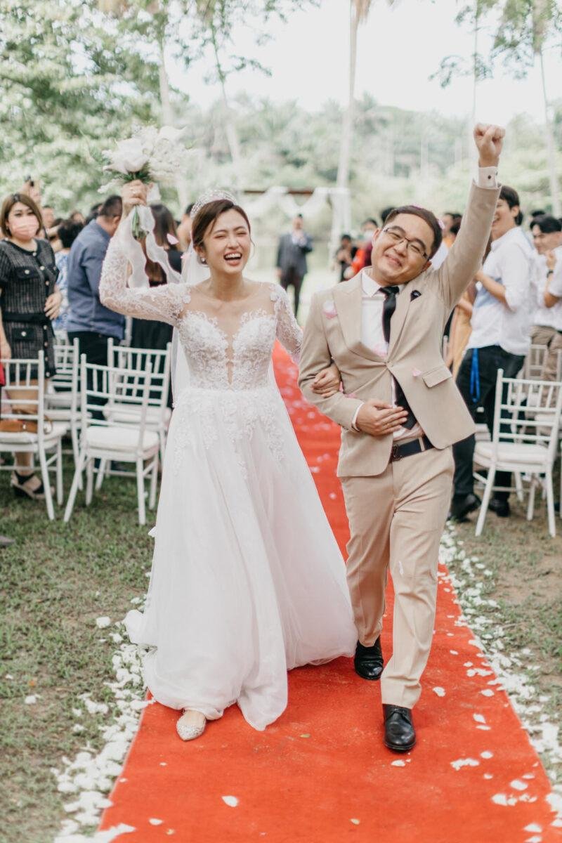 wedding couple happily march out for a garden wedding at The Saujana Hotel Subang Jaya