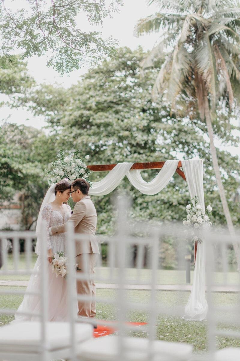 wedding couple exchange vows at a garden wedding at The Saujana Hotel Subang Jaya