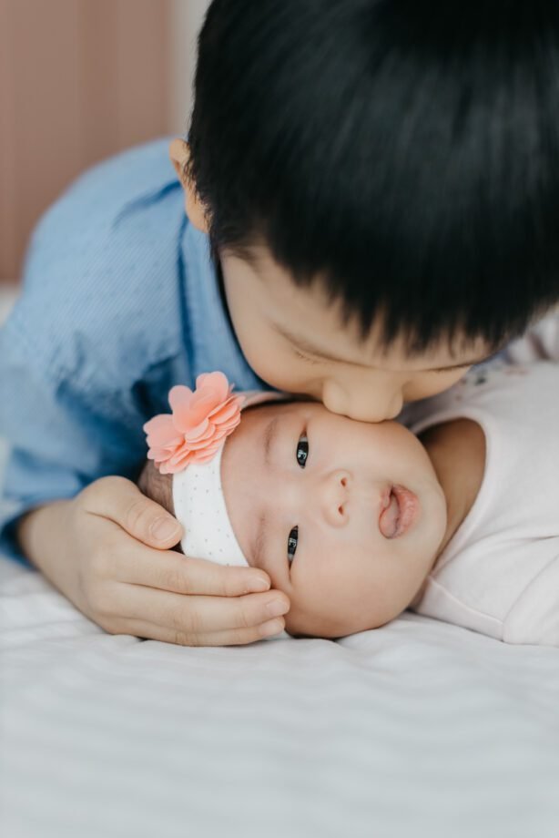 Newborn photography capturing sibling bond by cliff choong Photography Malaysia