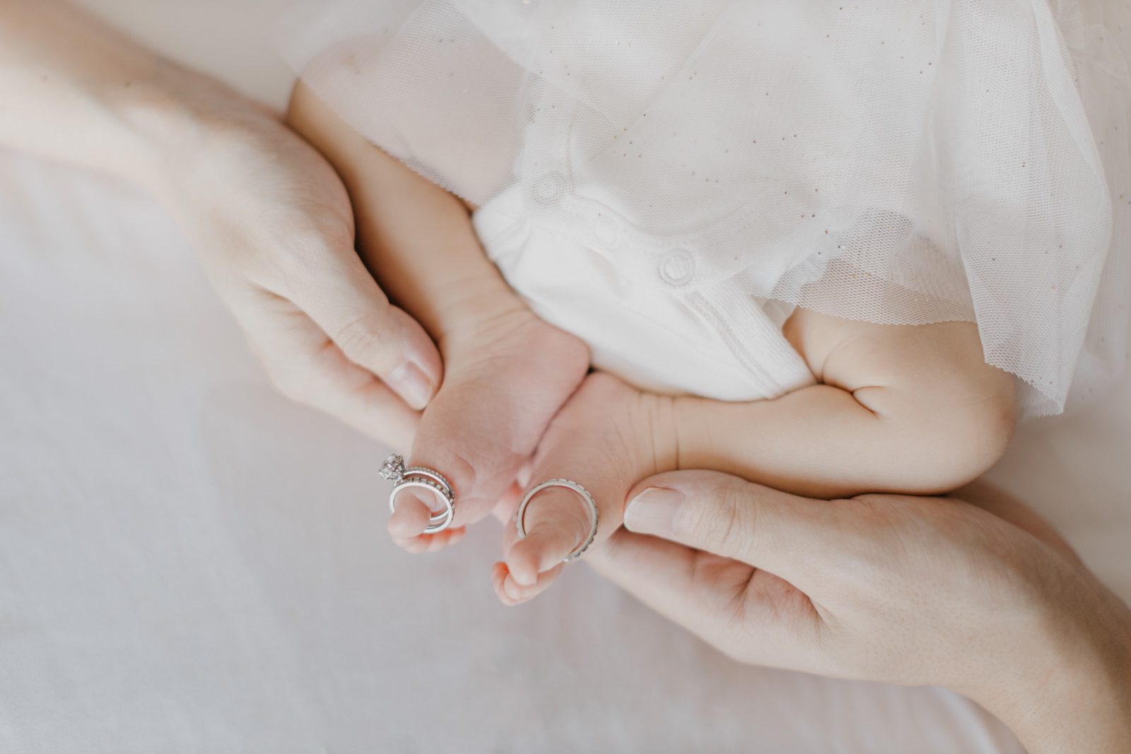 Little Kiko and her parents sharing a tender moment of love Newborn Photography Mini Session