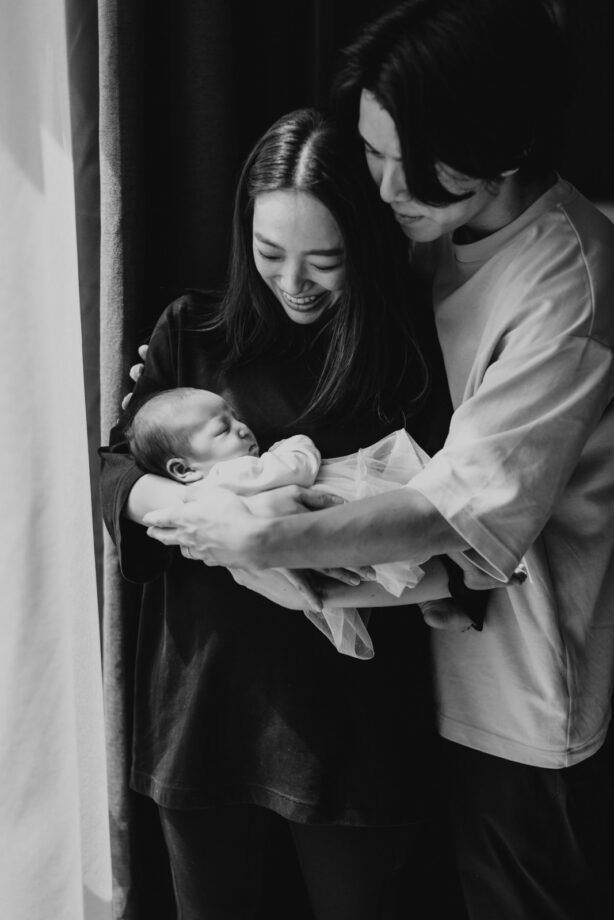 Peaceful newborn daughter, Little Kiko, sleeping soundly Little Kiko and her parents sharing a tender moment of love Newborn Photography Mini Session