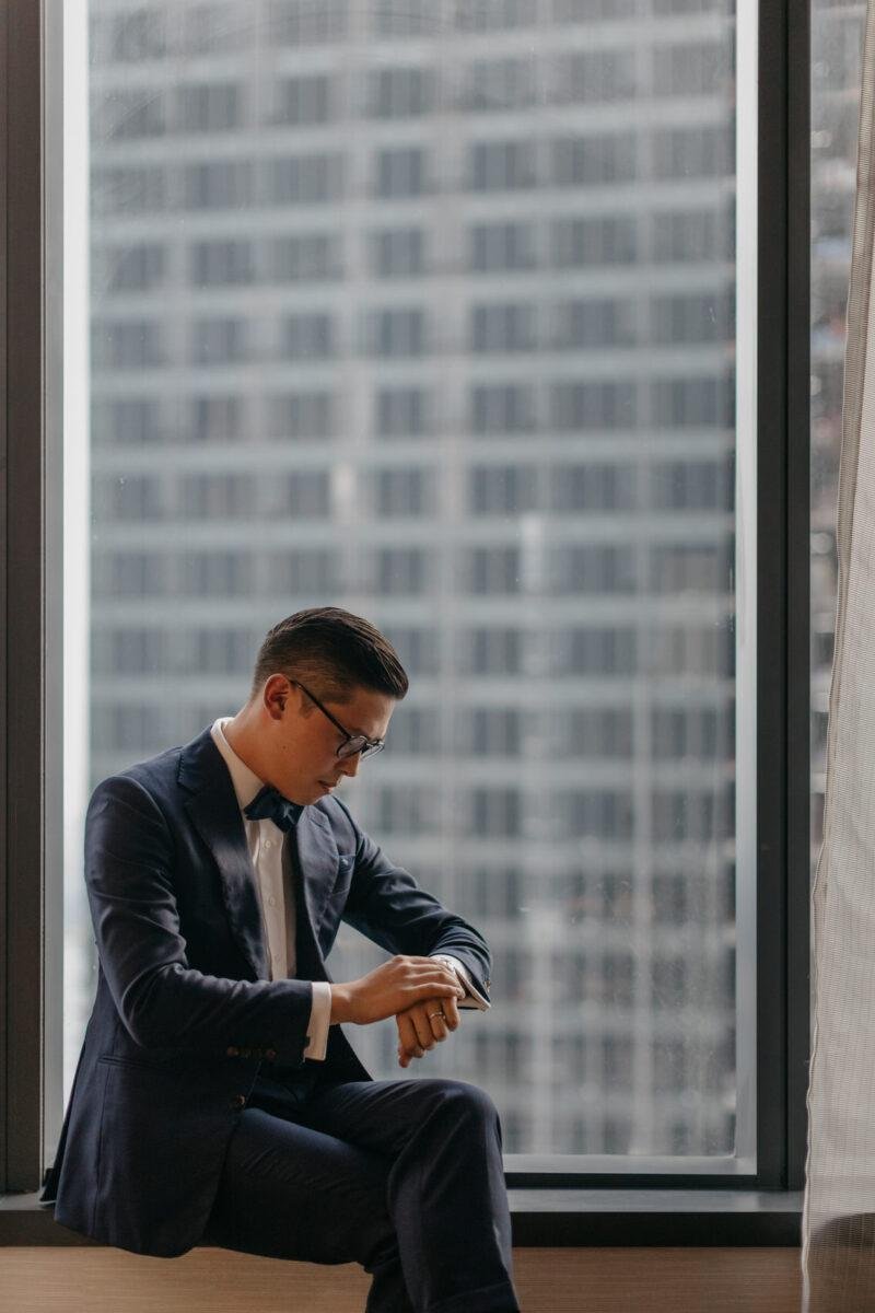 KL tower view. Groom getting ready. A dreamy and romantic, moon-themed wedding reception at The Equatorial Hotel Kuala Lumpur. Liyana and Carlos's love shone bright like the moon at this magical venue.