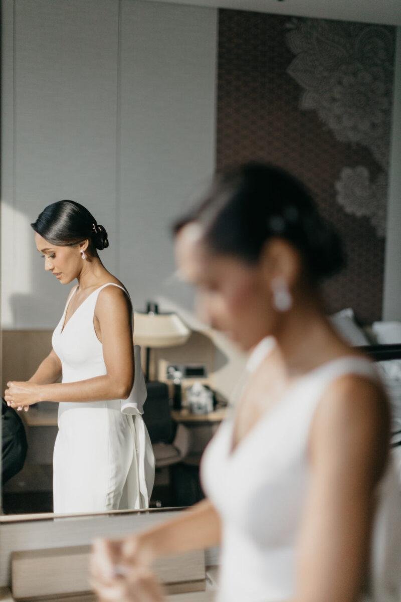 bride getting ready. A dreamy and romantic, moon-themed wedding reception on the famous rooftop of The Equatorial Hotel Kuala Lumpur. Liyana and Carlos's love shone bright like the moon at this magical venue.