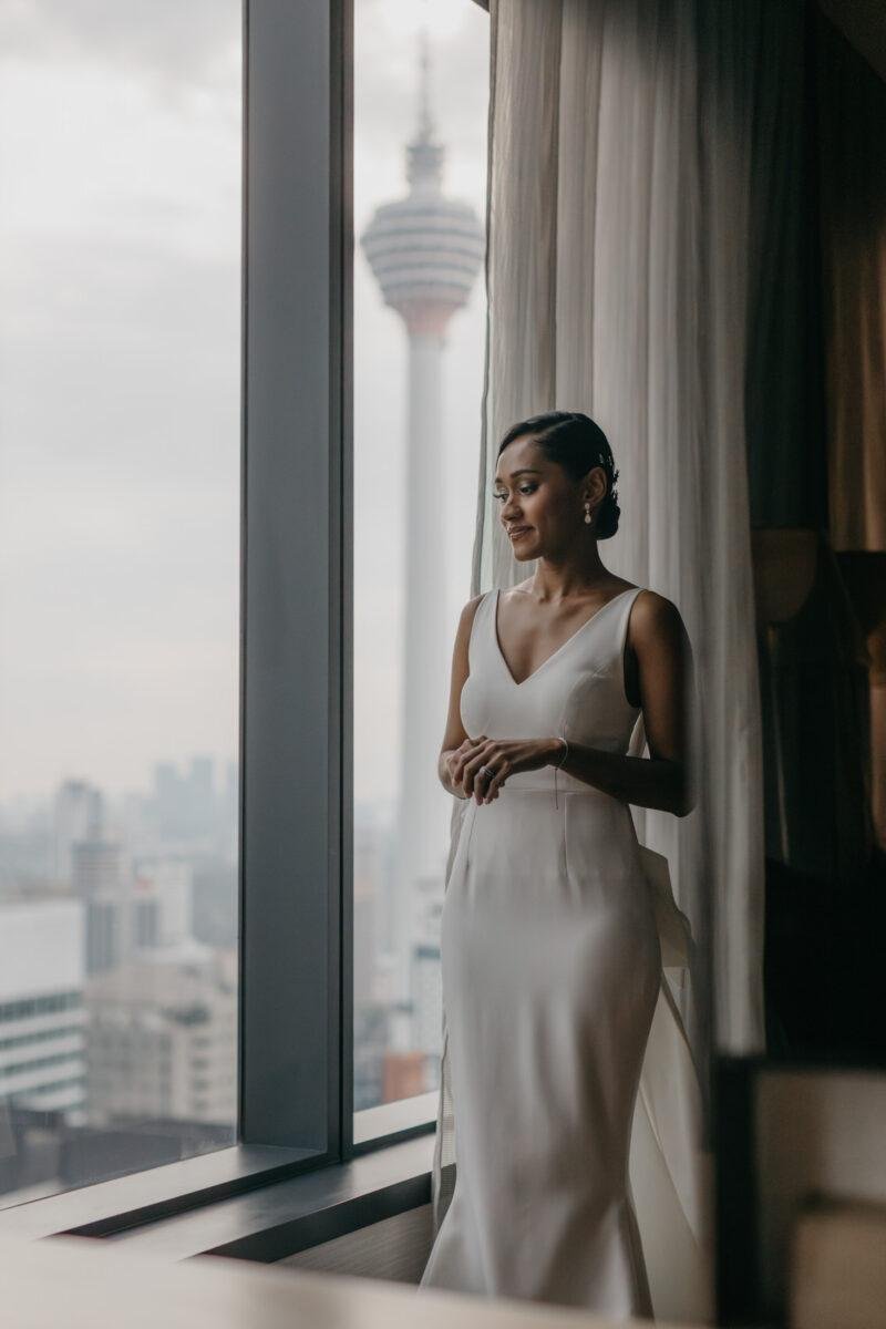 bride getting ready. A dreamy and romantic, moon-themed wedding reception on the famous rooftop of The Equatorial Hotel Kuala Lumpur. Liyana and Carlos's love shone bright like the moon at this magical venue.