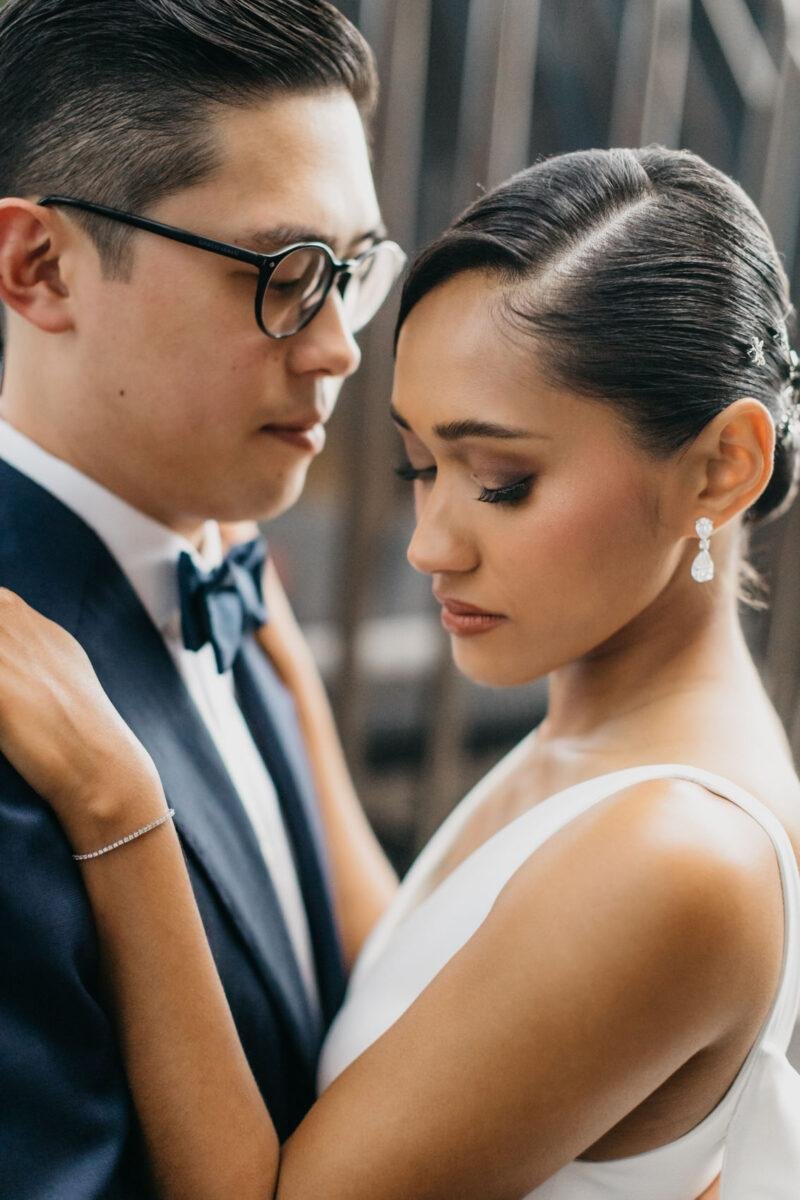 bride and groom photos on the rooftop of EQ Hotel Kuala Lumpur with KL tower as a backdrop. A dreamy and romantic, moon-themed wedding reception on the famous rooftop of The Equatorial Hotel Kuala Lumpur. Liyana and Carlos's love shone bright like the moon at this magical venue.