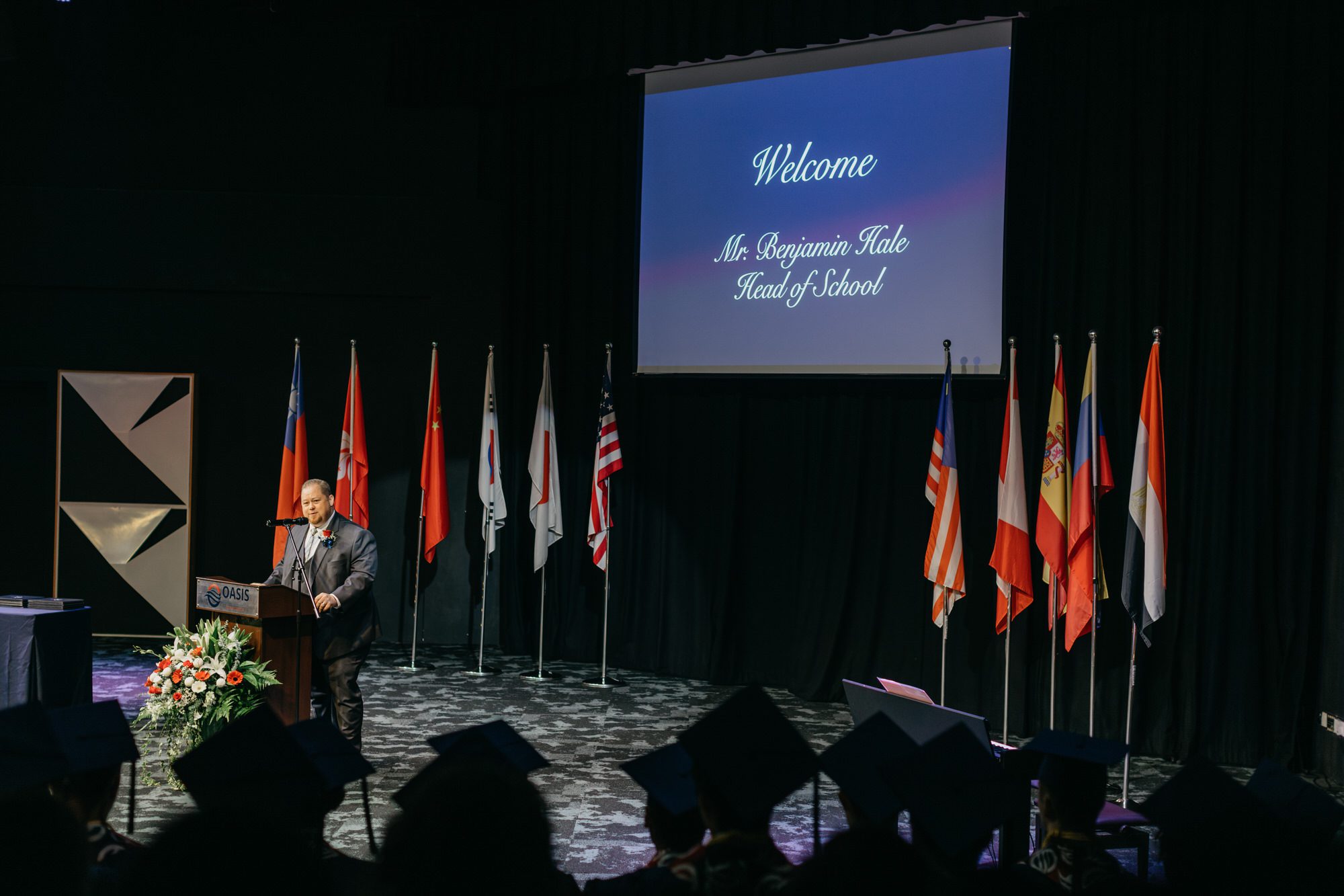A beautifully decorated venue with a small audience, creating an intimate atmosphere for the Oasis International School 2023 graduation ceremony.