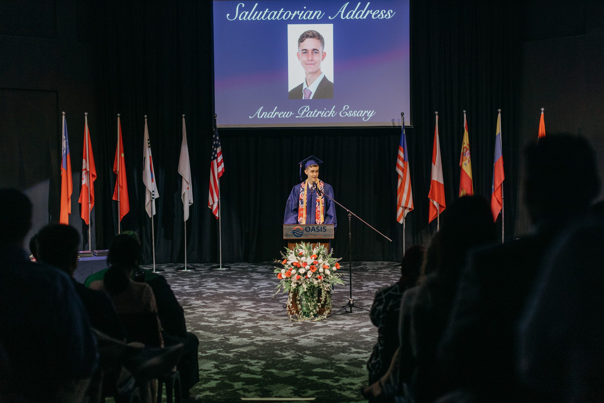 student addressing the audience with passion and enthusiasm, delivering a memorable salutatorian speech at the Oasis International School 2023 graduation ceremony.