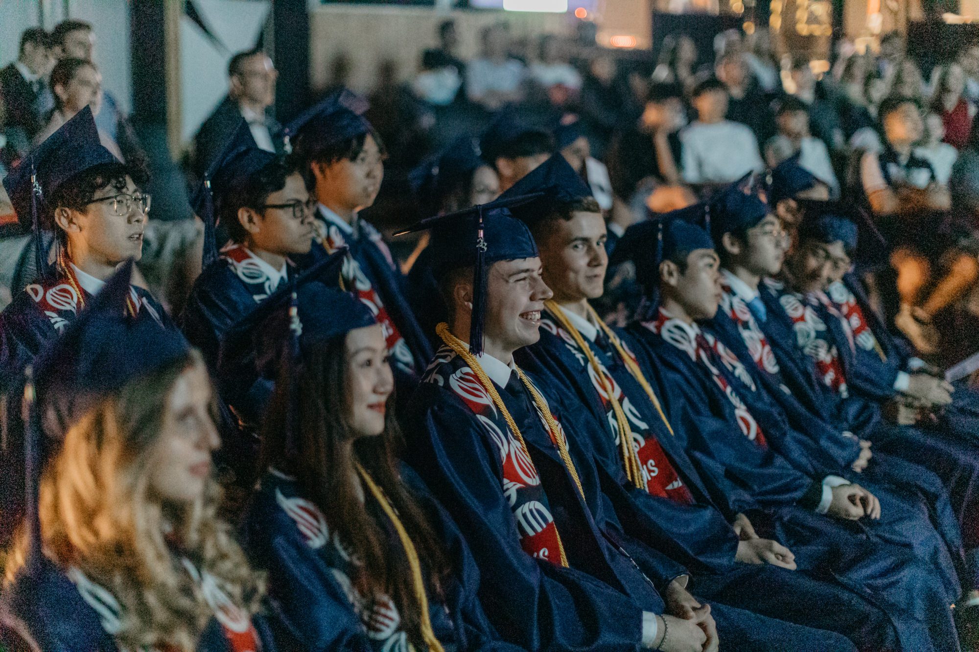A group of graduates wearing graduation gowns and caps, celebrating their achievement at Oasis International School Kuala Lumpur 2023.