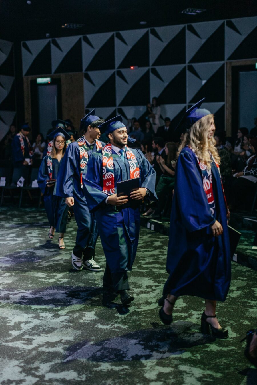A group of graduates wearing graduation gowns and caps, celebrating their achievement at Oasis International School Kuala Lumpur 2023.