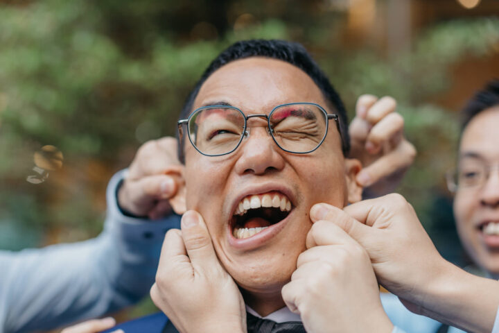 Joyful moments shared among friends and family during a wedding celebration by cliff choong photography