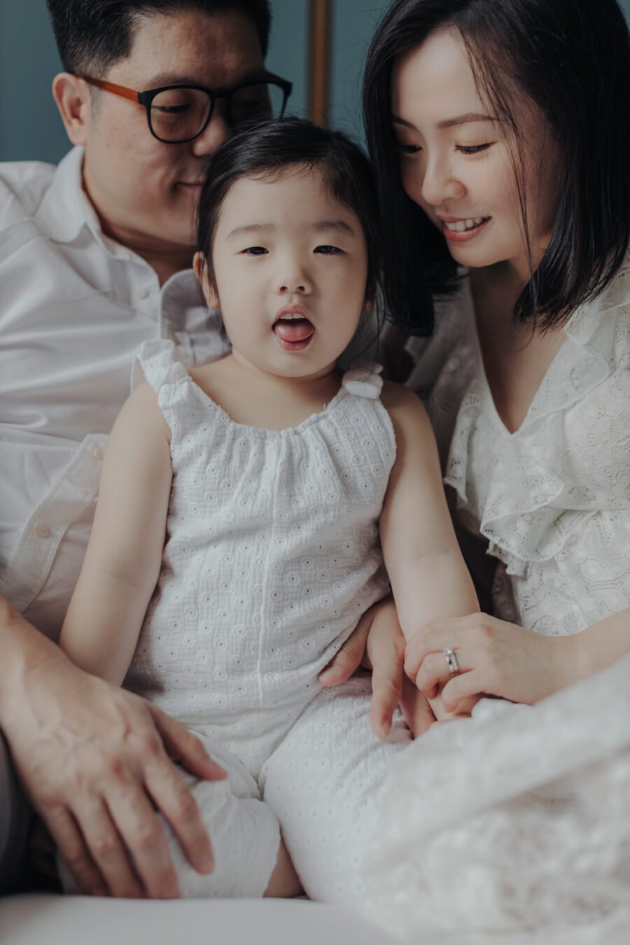 *Family Close-up:** A close-up shot of KimSun, Rachel, and Naomi sitting together on the bed, showing their close family bond.