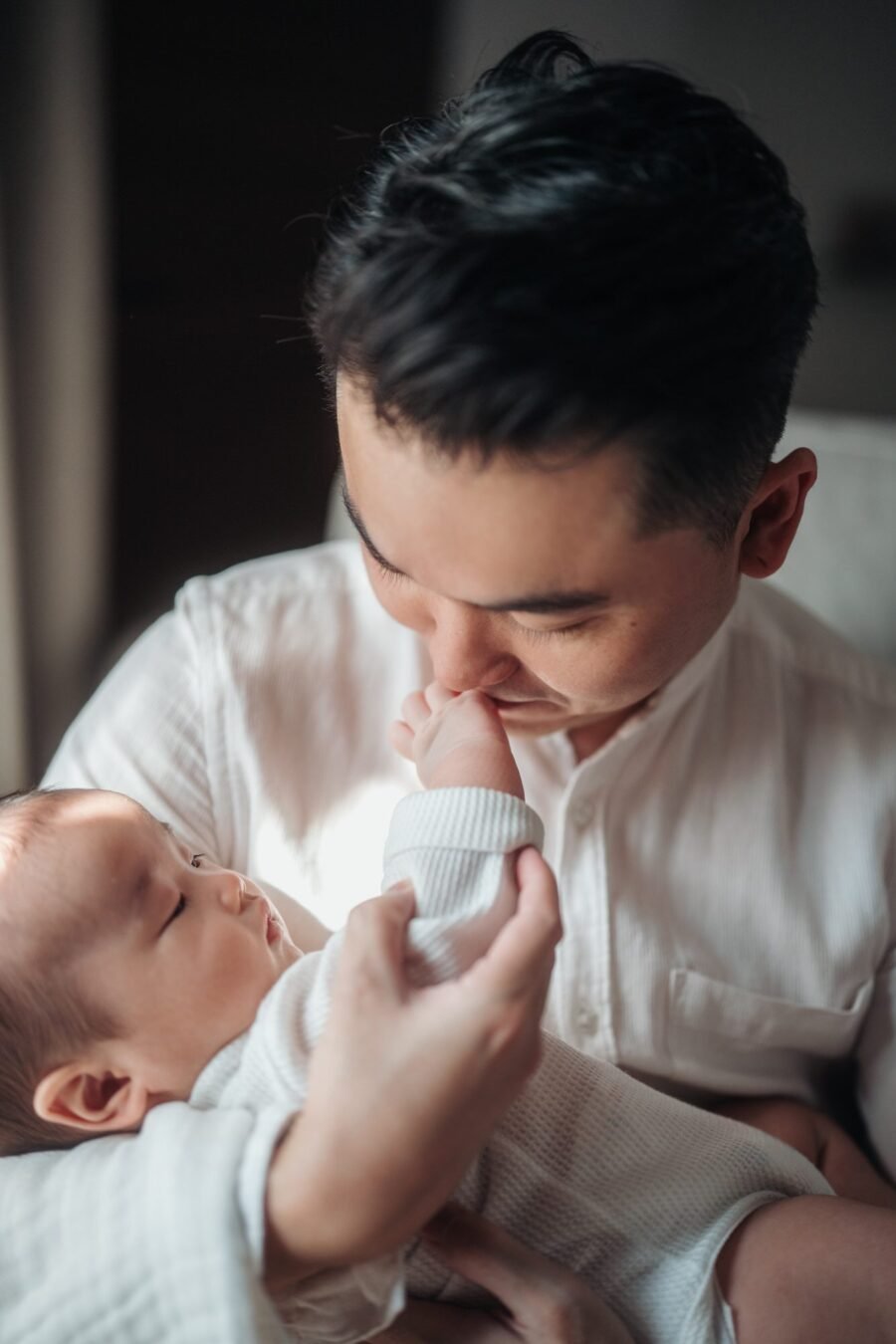 Heartwarming father and baby moment in milestone photoshoot