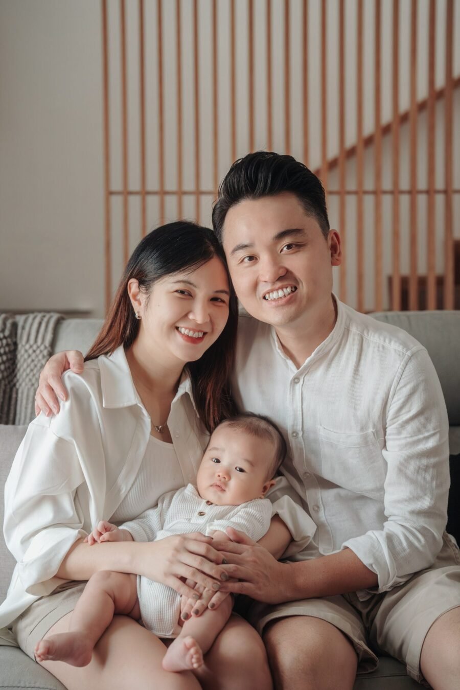 Parents holding baby during 100-day portrait session – Cliff Choong Photography