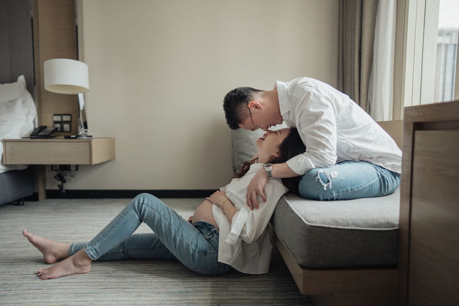 Candid shot of RuYiin during a maternity portrait session at JW Marriott Hotel Kuala Lumpur, filled with anticipation.