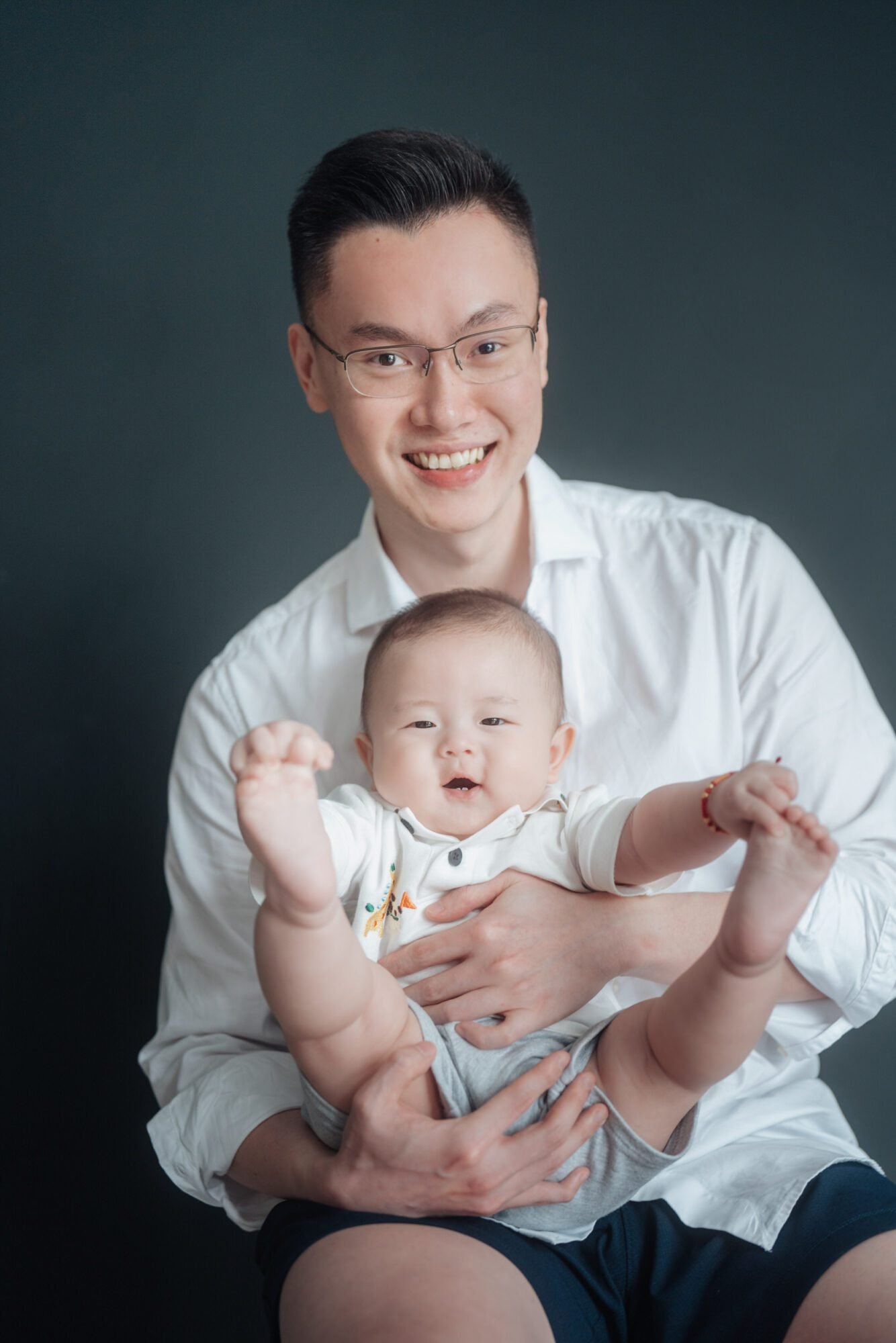 father holding newborn during studio family photo session in KL