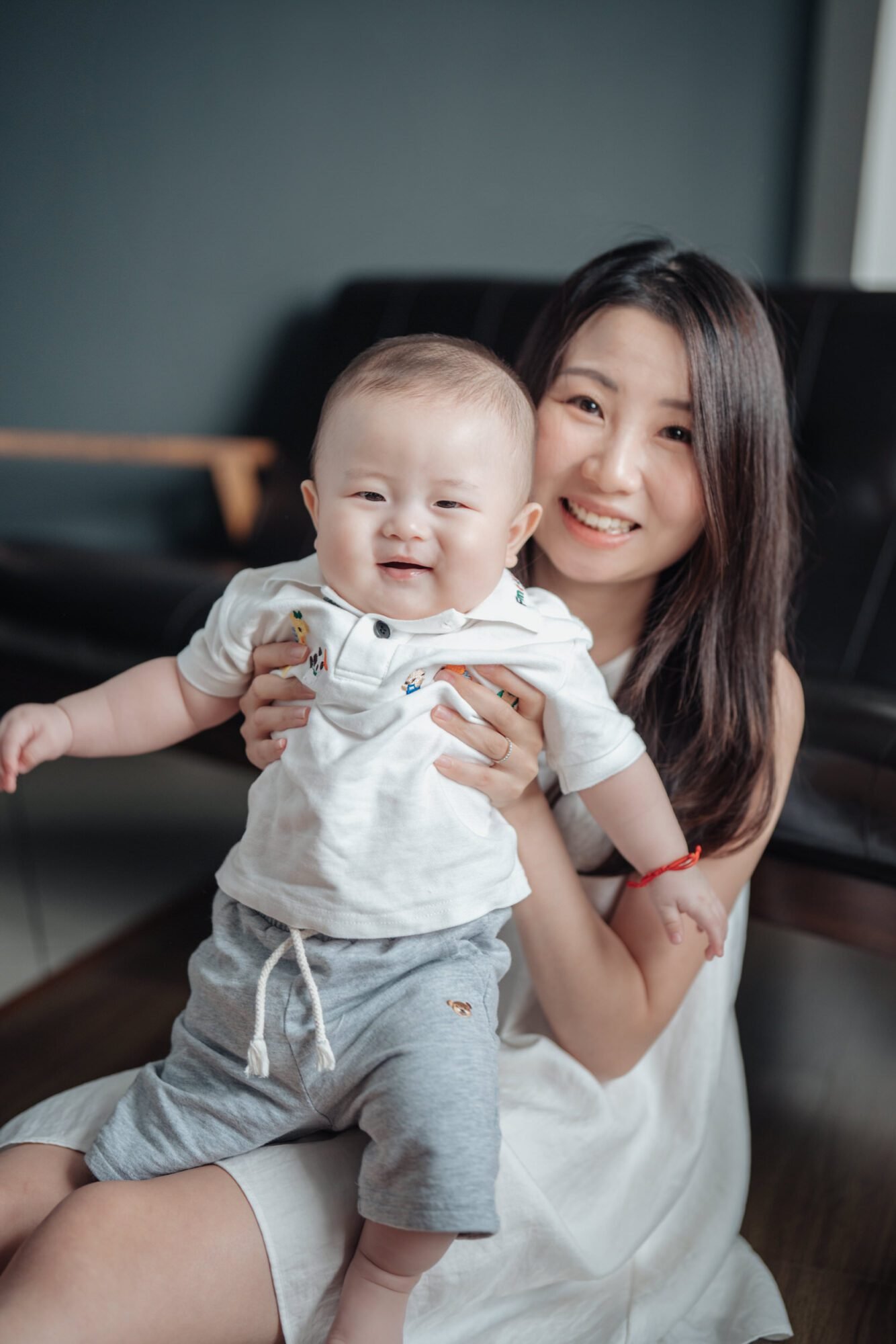 mother holding newborn during studio family photo session in KL