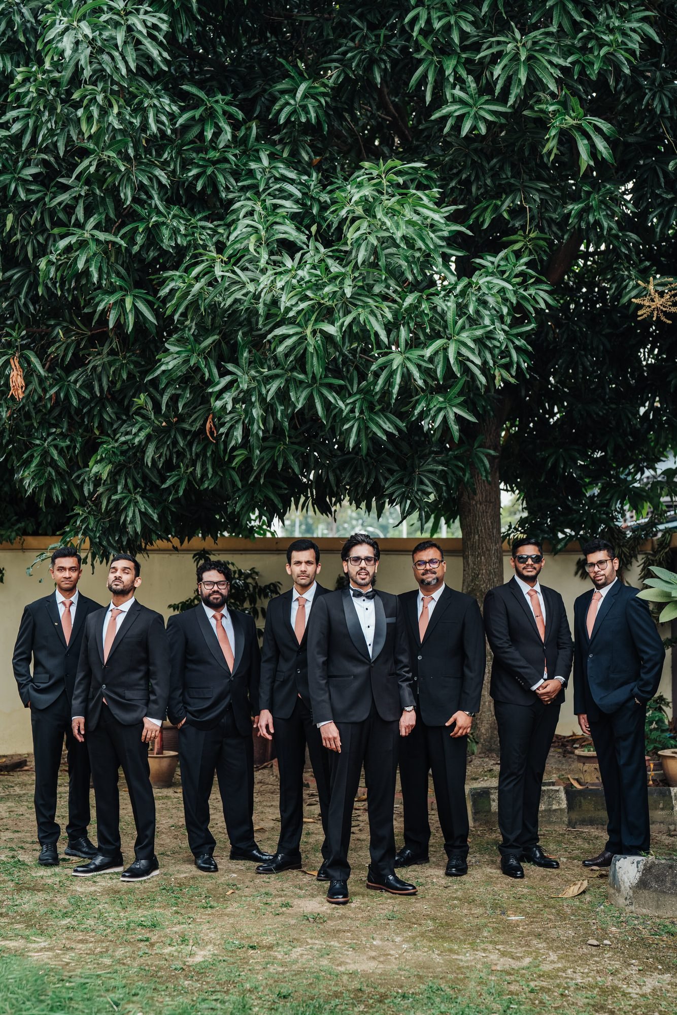 Groom and groomsmen together before a St. Thomas More Church wedding