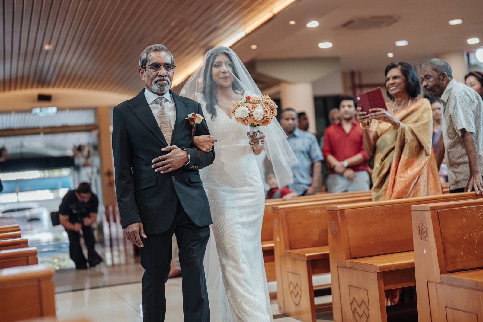 Bride and father marching in at the Wedding ceremony inside St. Thomas More Church in Subang Jaya