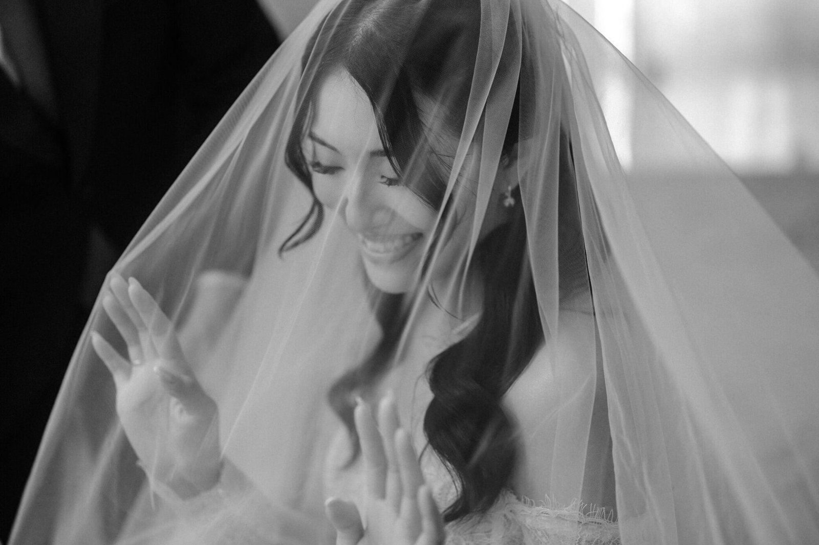 Silver smiling beneath her bridal veil before the ceremony photographed by Cliff Choong Photography